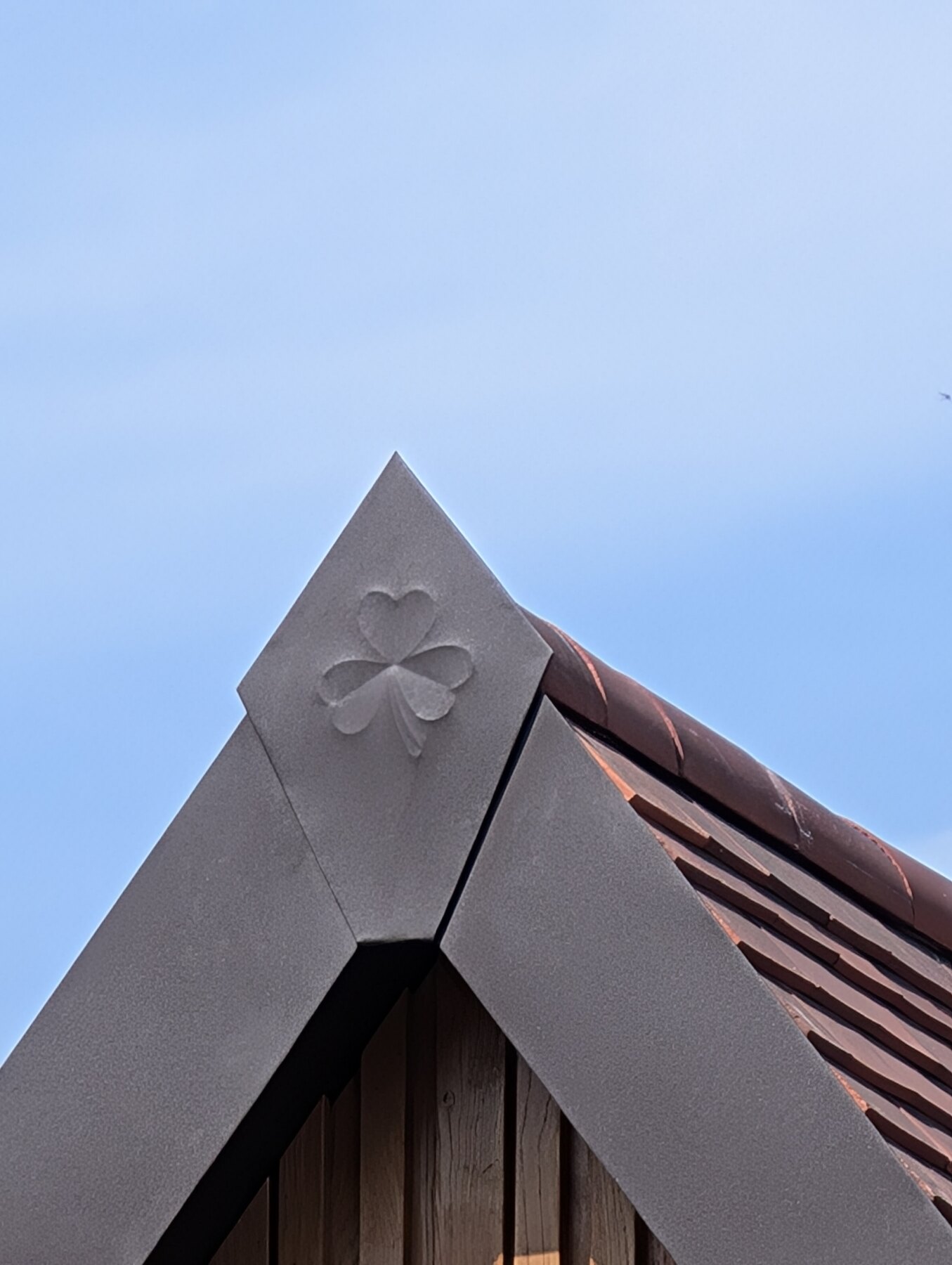 Bespoke clover detail formed into PREFA metalwork at a roof verge