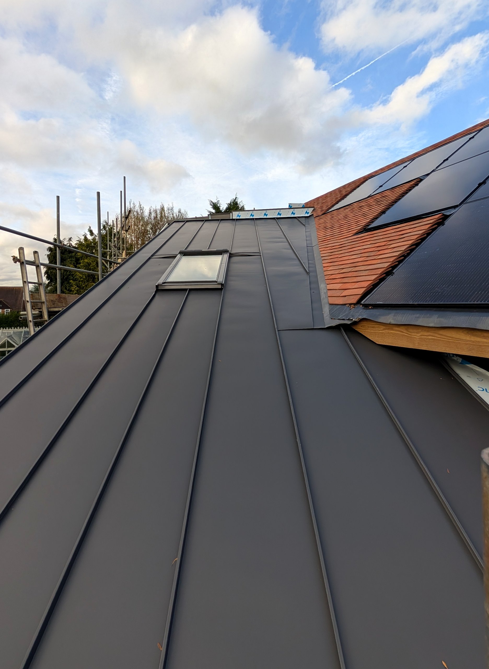 Construction detail showing rooflight integration and standing-seam layout