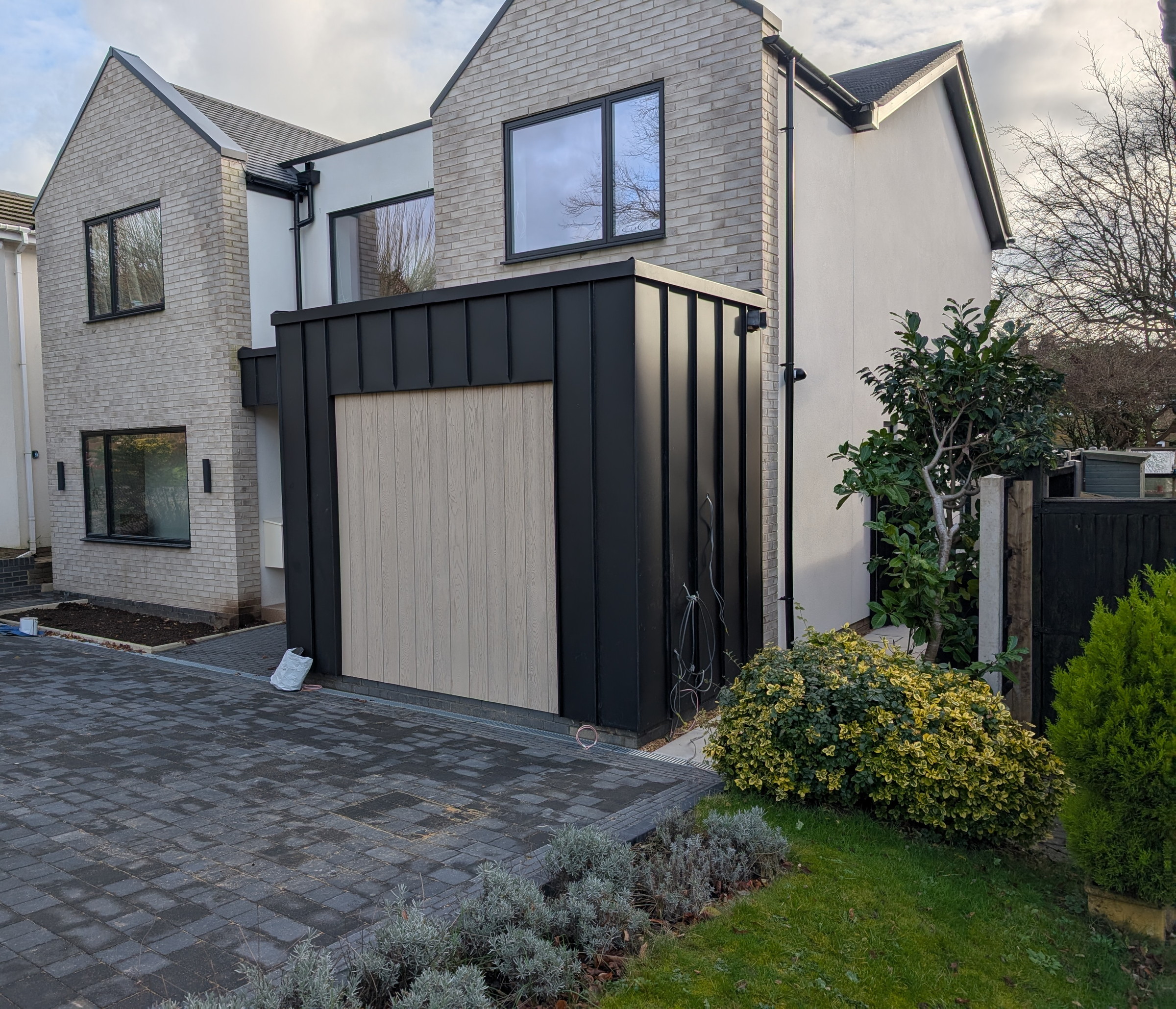Finished PREFA Black secret door cladding in wider architectural context