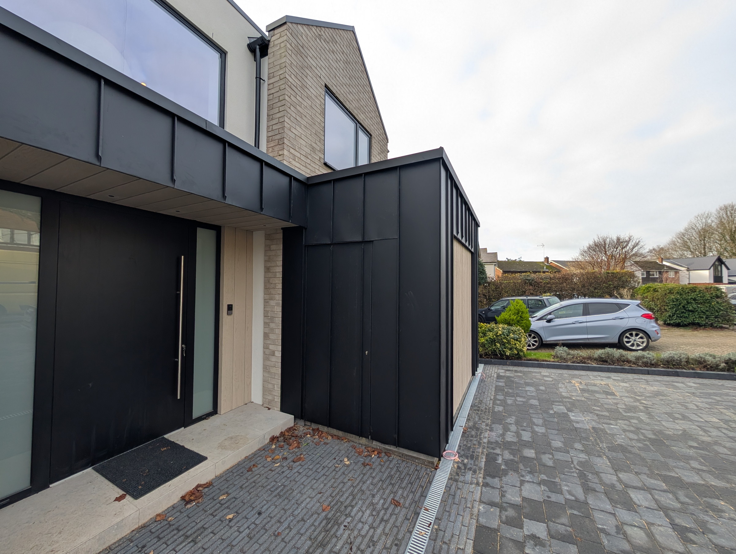 Finished PREFA Black entrance and concealed door detail