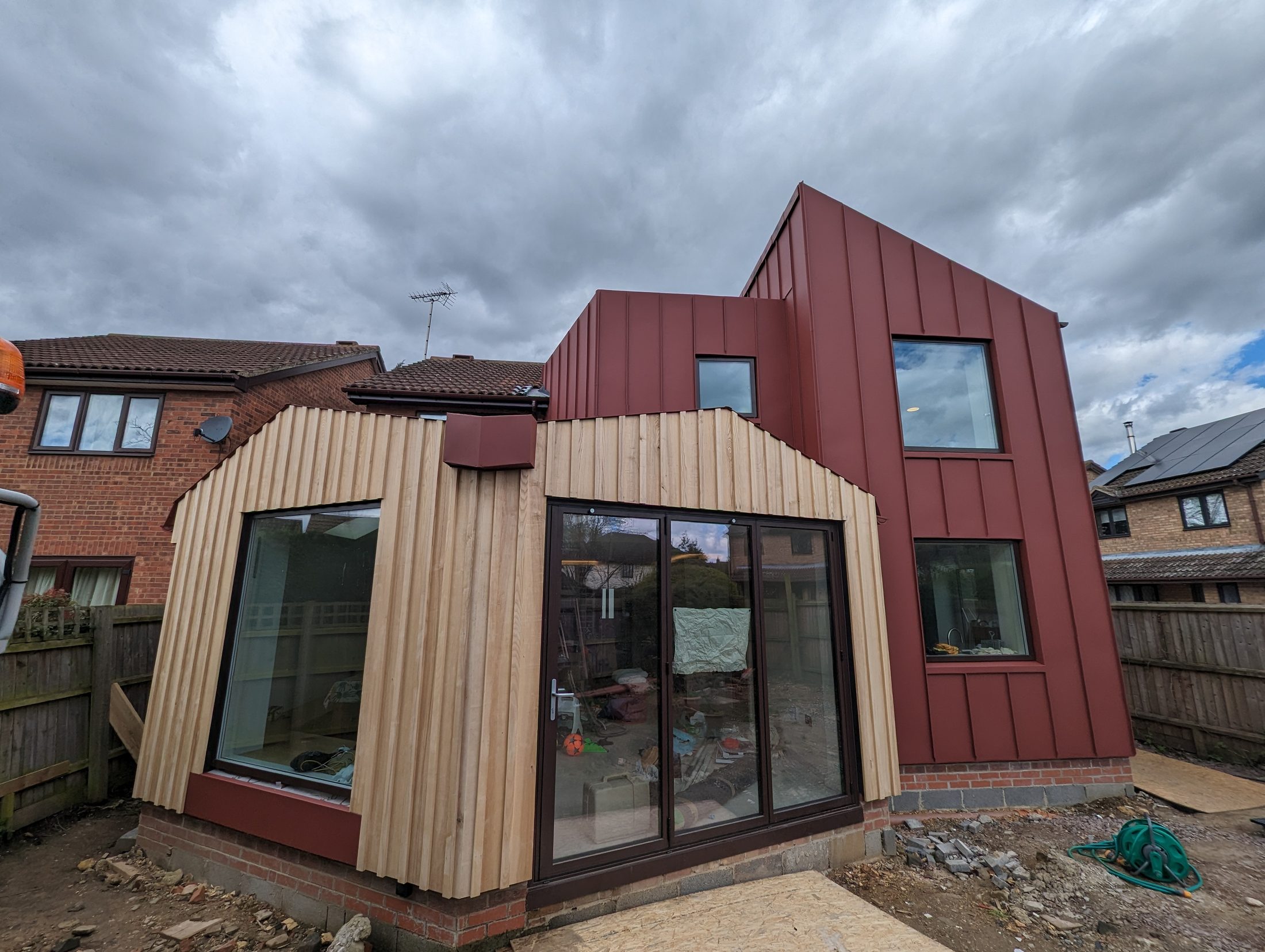 Red PREFA roofing and cladding home extension