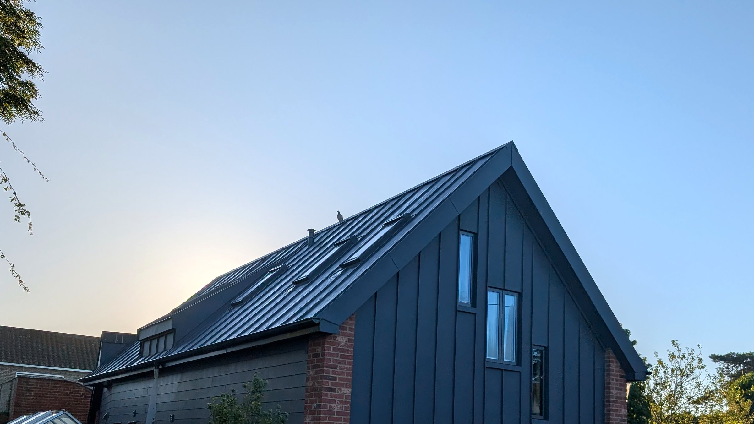 Finished standing-seam roof and cladding viewed from the side