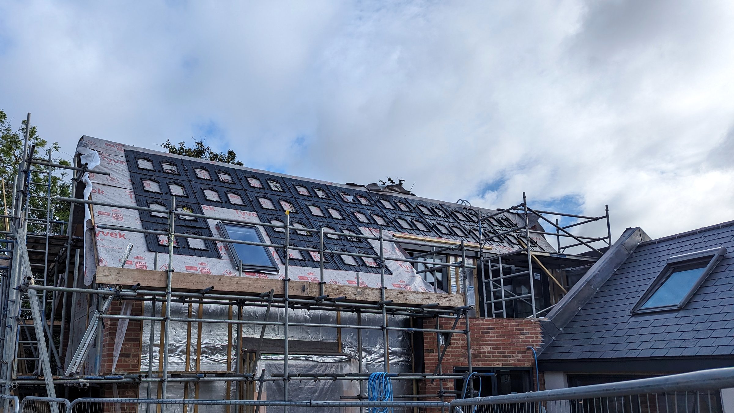 Standing-seam roof installation during construction